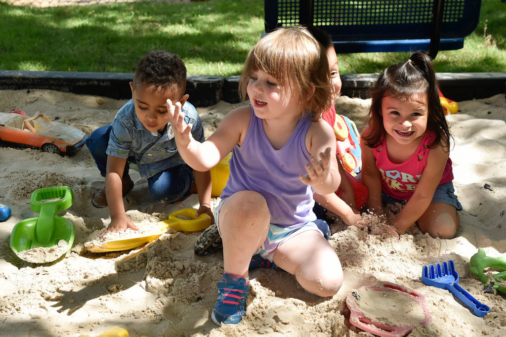 Children have fun on a newly built play area at Fred Moore Day Nursery School. Floyd Smith Concrete is the company that built the play area at Fred Moore Day Nursery School. The company is building it through a grant.